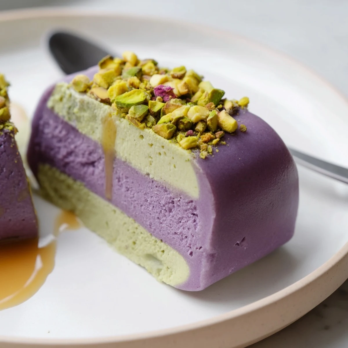 Vibrant ube and nutty pistachio layers create a stunning dessert treat.  