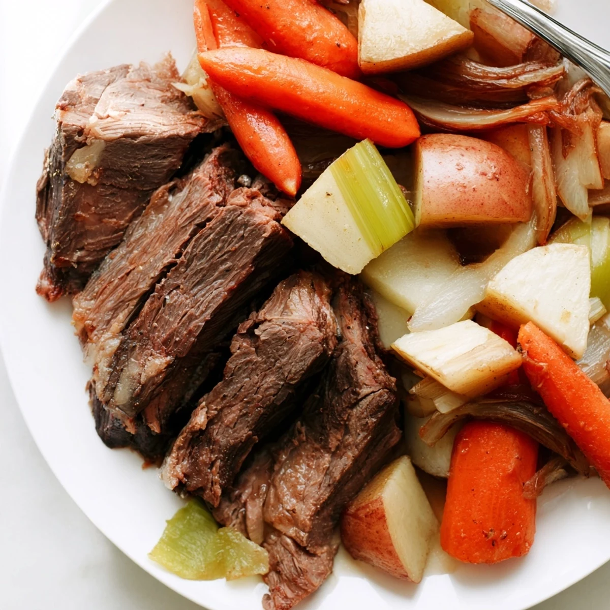 Tender Sunday Pot Roast surrounded by colorful roasted veggies, ideal for family meals.  