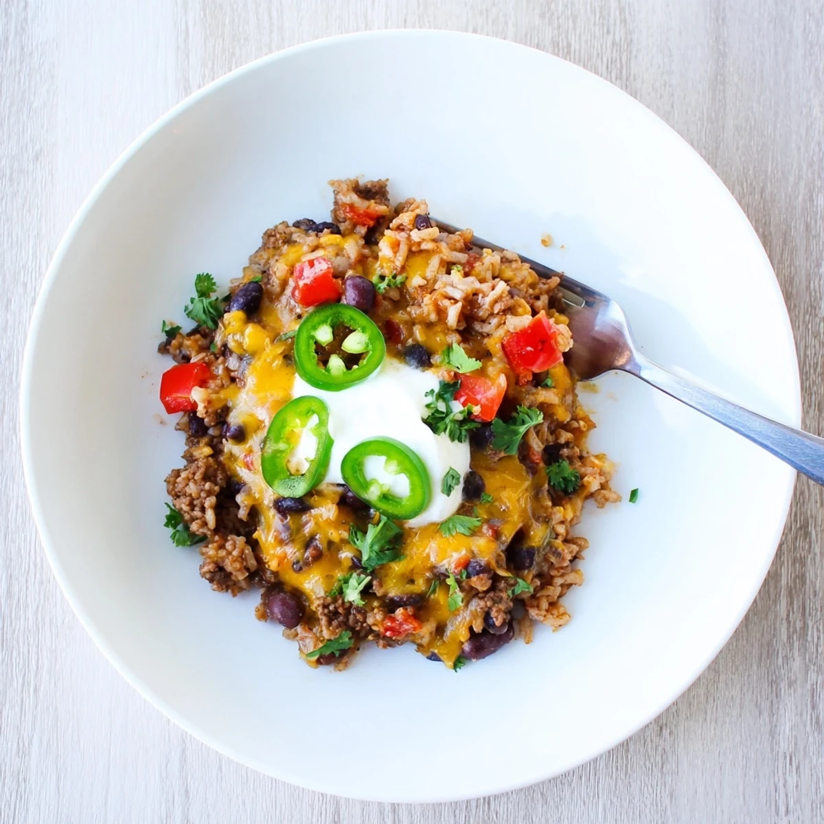 Hearty Tex-Mex Beef & Rice Casserole with melted cheese and vibrant toppings.  