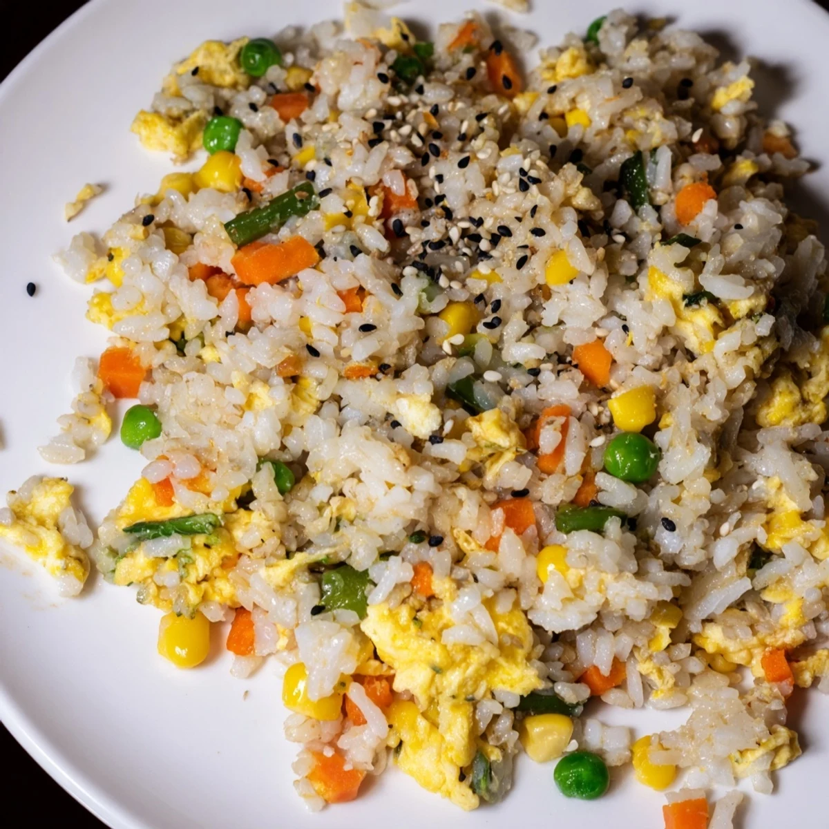 Steaming Frozen Veggie Fried Rice with fluffy scrambled eggs, and fragrant soy sauce, ready to serve!