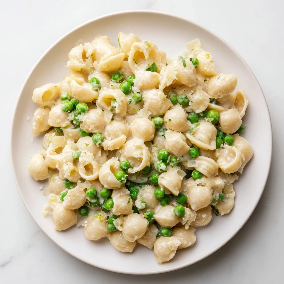 Macaroni & Peas, creamy and comforting, with tender pasta, sweet peas, and Parmesan cheese.