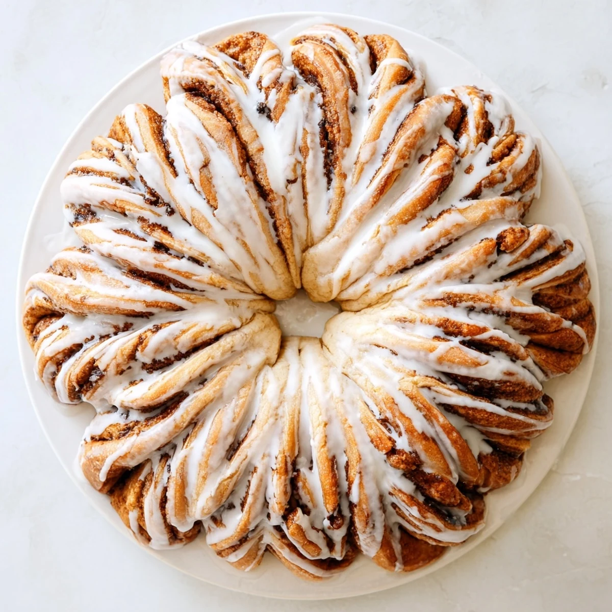 Freshly baked giant snowflake sweet rolls ready to be served, soft pull-apart rolls arranged in a snowflake shape.