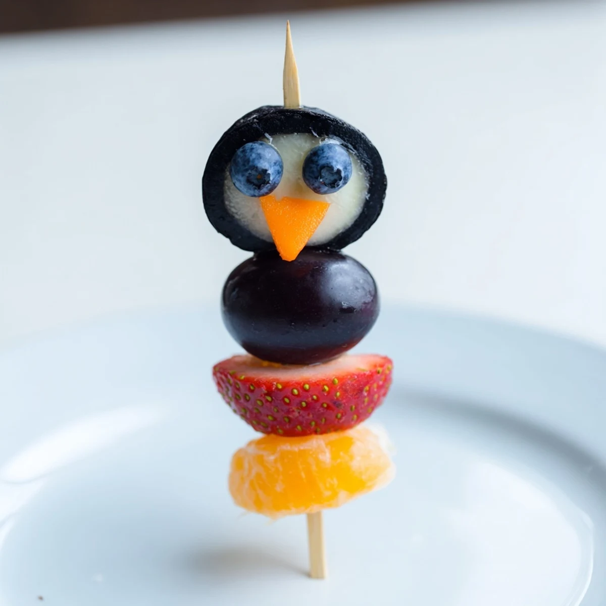 Vibrant Penguin Fruit Skewer Army with juicy grapes and strawberries, a fun and healthy snack.