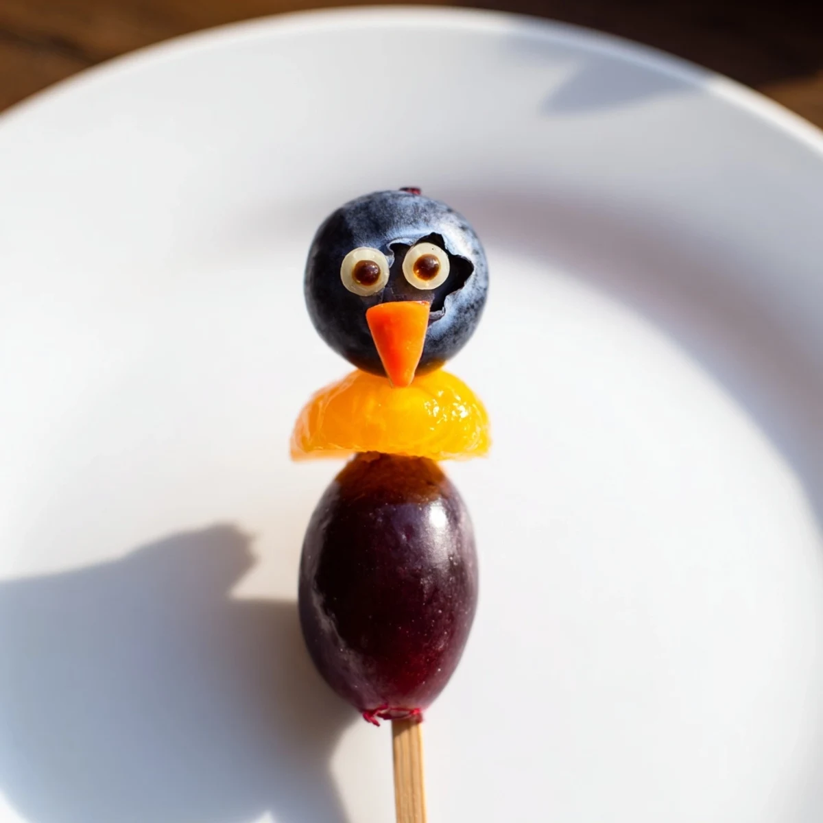 Freshly assembled Penguin Fruit Skewer Army featuring colorful fruit, a playful and delicious kids' party treat.