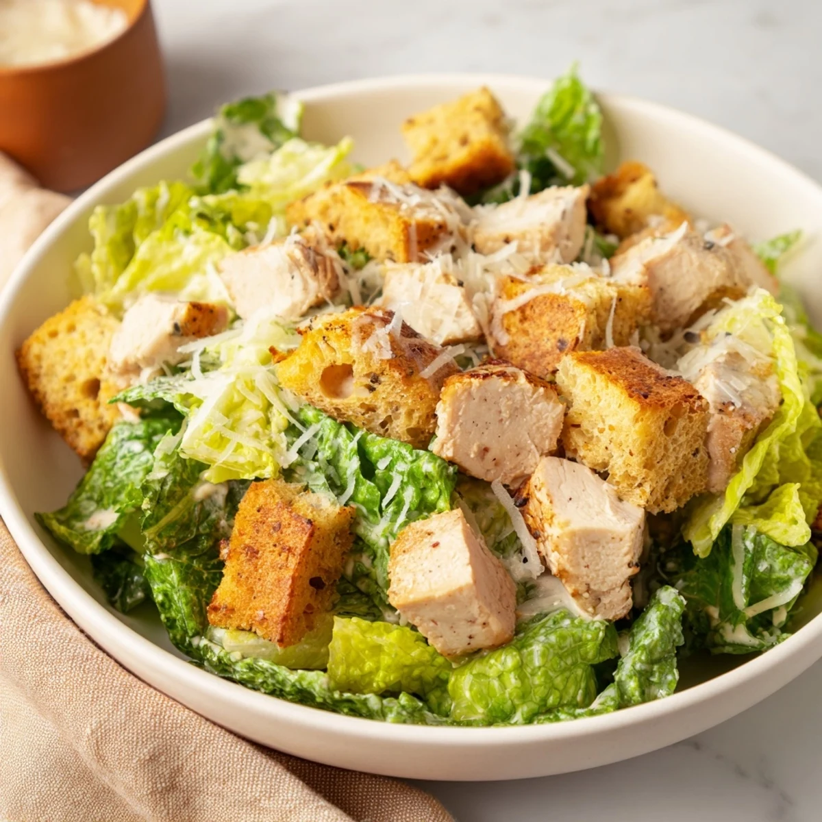 Close-up of Chicken Caesar Salad Skewers: grilled chicken, romaine, and croutons drizzled with creamy dressing.