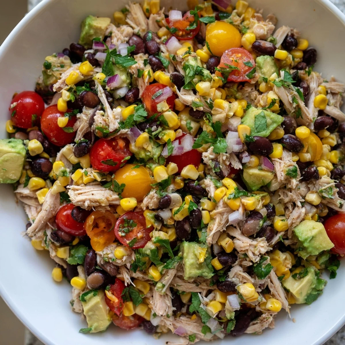 Hearty Southwestern Bean Salad, a vibrant mix of black beans, chicken, and fresh vegetables ready to serve.