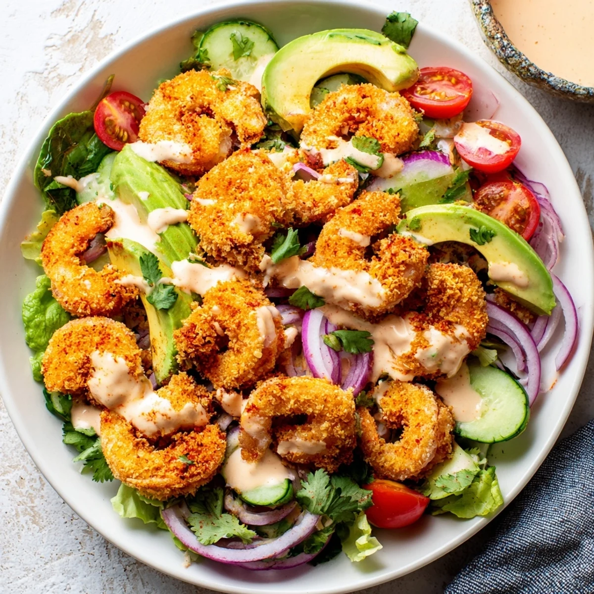 Fresh, crunchy romaine topped with a colorful Spicy Crispy Shrimp Salad, ready to enjoy.