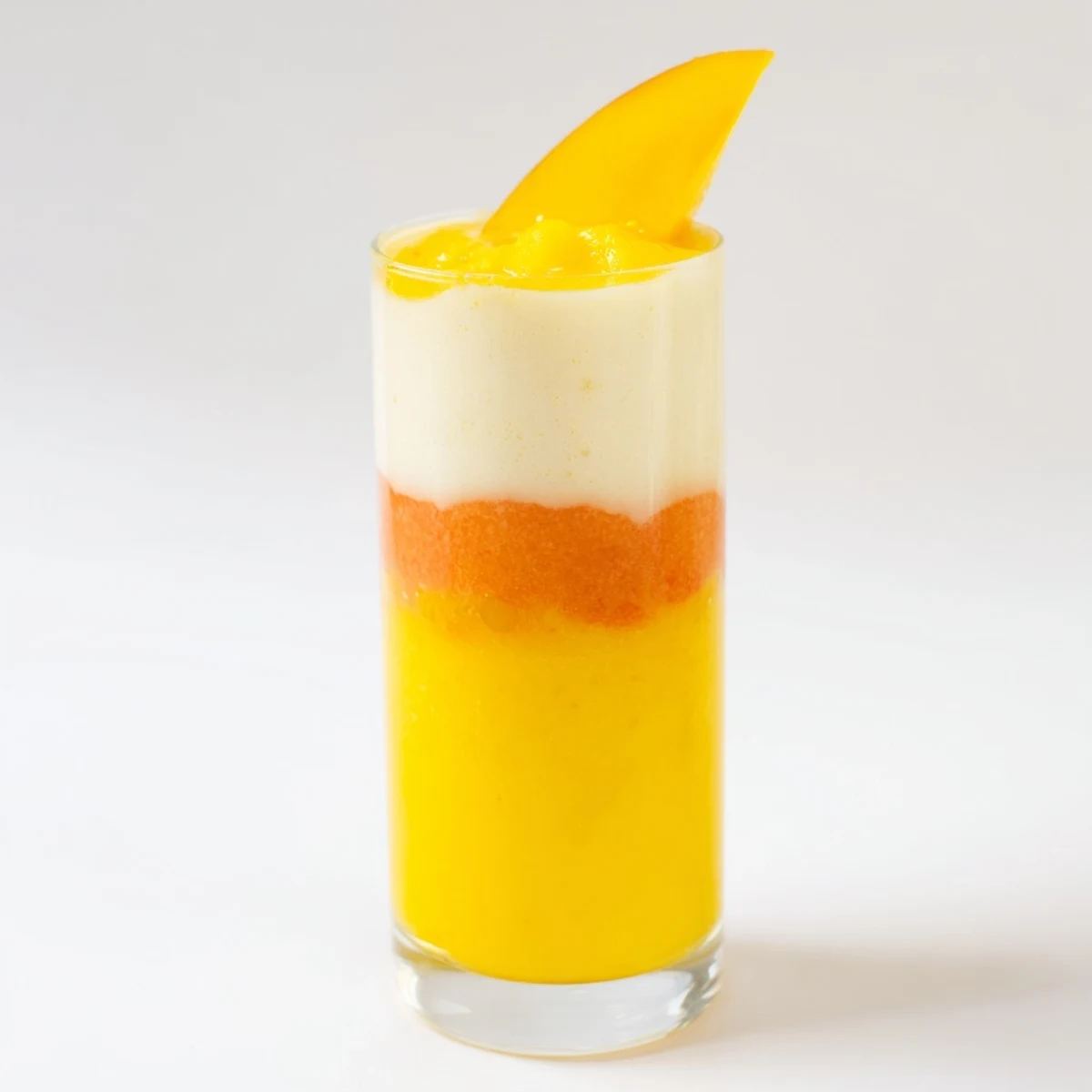 A close-up of a layered Tropical Sunset Smoothie, showcasing creamy yogurt and fresh fruit for a bright start.