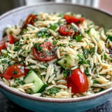 Tender orzo salad bursting with fresh herbs and bright citrus, served warm.