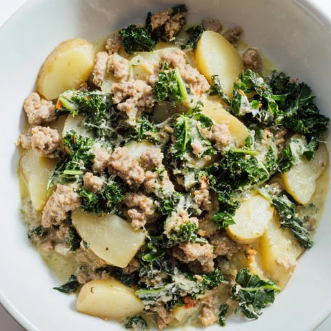 Creamy Instant Pot Pesto Zuppa Toscana bursting with sausage, potatoes, and fresh kale.