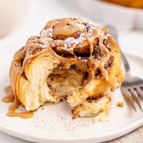 Golden Peanut Butter Maple Breakfast Rolls, fresh from the oven, glazed and ready to eat.