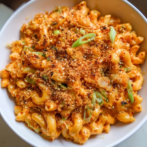 Creamy Spicy Kimchi Mac & Cheese topped with crunchy sesame breadcrumbs and spring onions.  