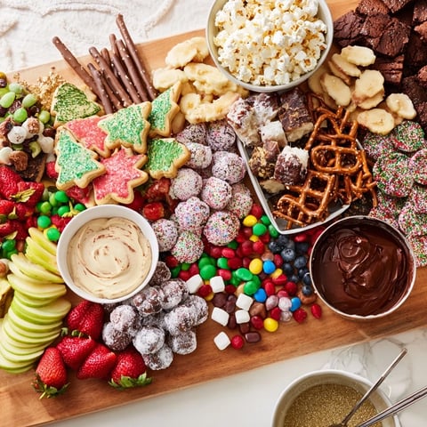 A colorful dessert board with themed snacks and vibrant fruits, perfect for celebrations.  