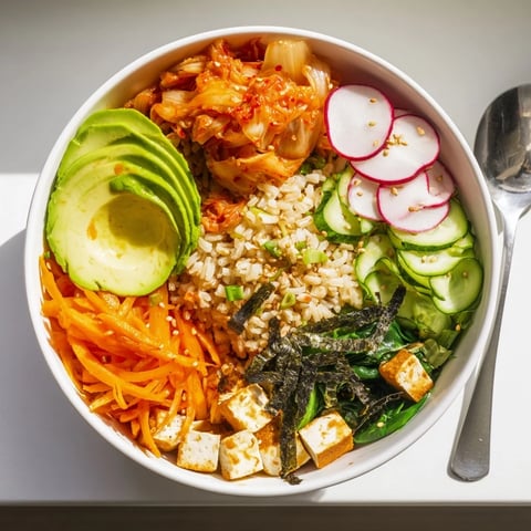 A colorful Fermented Vegetable Bowl filled with kimchi, fresh veggies, and grains.  