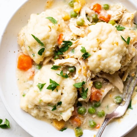A comforting Chicken and Dumplings Casserole with golden dumplings and creamy sauce.  