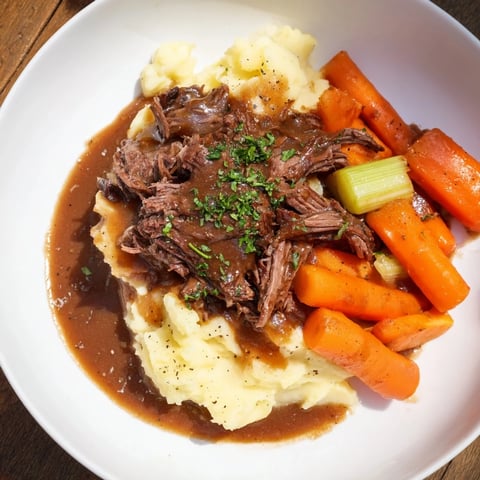 Tender slow cooker pot roast with carrots and potatoes, a hearty family meal.