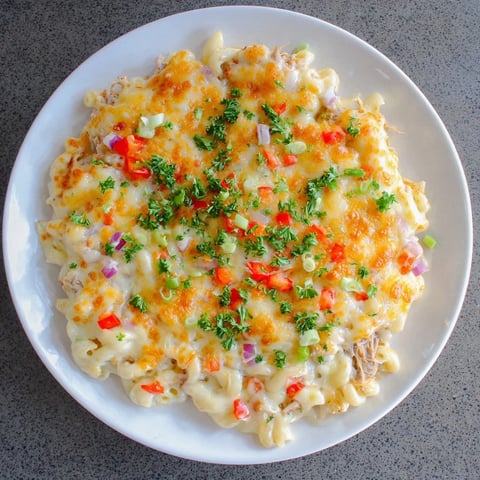 Delectable BBQ Rib Macaroni Skillet, bubbling hot and cheesy, garnished with fresh parsley.