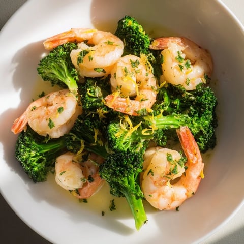 Golden, glistening Lemon Butter Shrimp & Broccoli, served with fresh parsley, looks incredibly delicious.