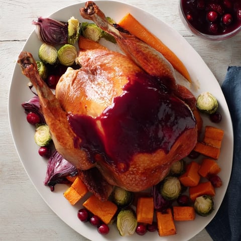 Juicy sheet-pan roasted turkey breast with colorful, caramelized winter vegetables and a vibrant cranberry glaze.