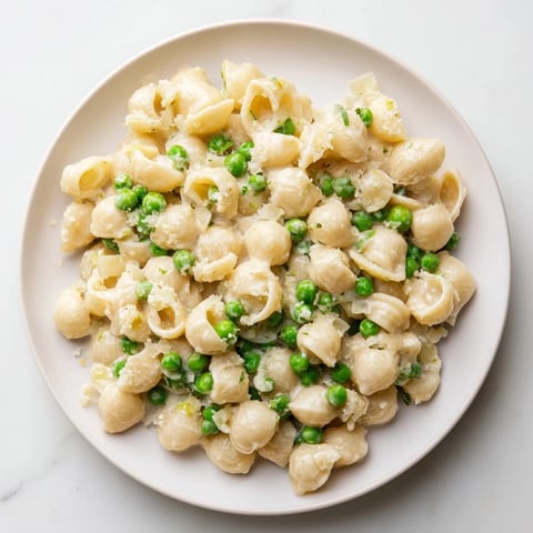 Macaroni & Peas, creamy and comforting, with tender pasta, sweet peas, and Parmesan cheese.