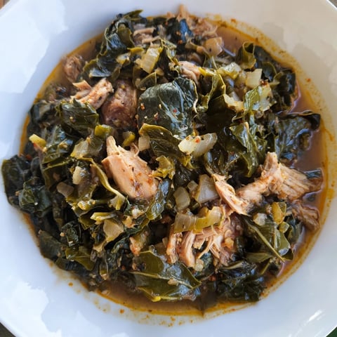 Steaming Southern collard greens with smoked turkey, a hearty, flavorful side dish for dinner.