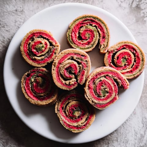 Vibrant Holiday Pinwheel Cookies: swirl of red and green dough, anticipating a delicious and festive treat.