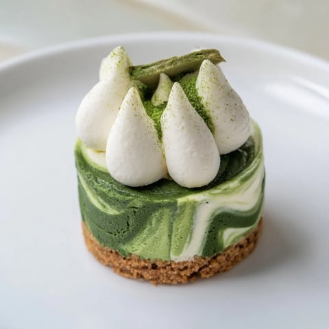 Creamy Matcha Swirl Snowdrift Cheesecake Cups swirled with vibrant green matcha, a decadent no-bake dessert.