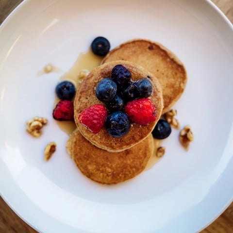 Fluffy, golden brown banana pancakes, cooked on the stovetop, ready for a delicious breakfast.