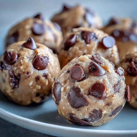 Golden-brown Vegan Chickpea Cookie Dough Bites with dark chocolate chips on a rustic plate.