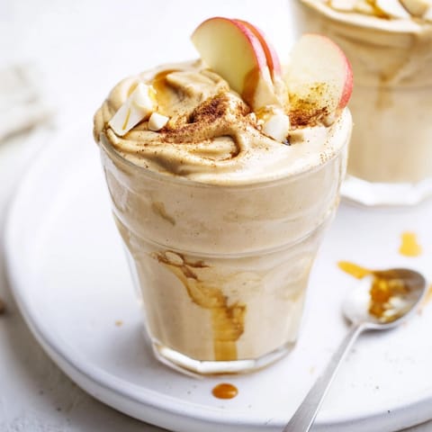 Close-up of a frothy Peanut Butter Apple Fall Smoothie, ready to enjoy chilled.