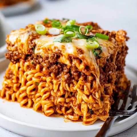 Delicious Spicy Ramen Lasagna layers filled with savory pork and rich tomato sauce.  