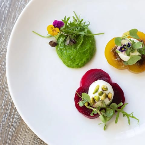 Lucky Clover Seasonal Starters: Bright green pea purée with beet carpaccio and goat cheese mousse, beautifully presented.