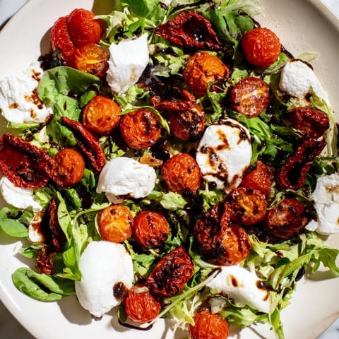 A colorful top-down shot of Tomato Flight Salad with its various tomatoes and burrata cheese ready to eat.