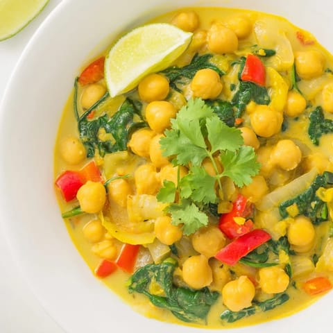 Golden-hued Chickpea Curry with vibrant red peppers is ready to enjoy for dinner tonight.
