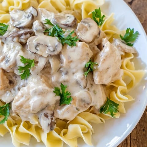 Golden chicken and sautéed mushrooms smothered in a rich, paprika-laced cream sauce for a comforting dinner.
