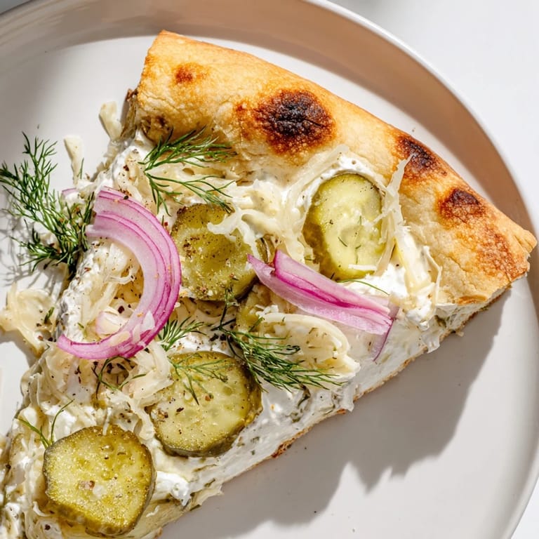 Deliciously cheesy Pickle Pizza topped with crunchy pickles and garlic crème fraîche.  