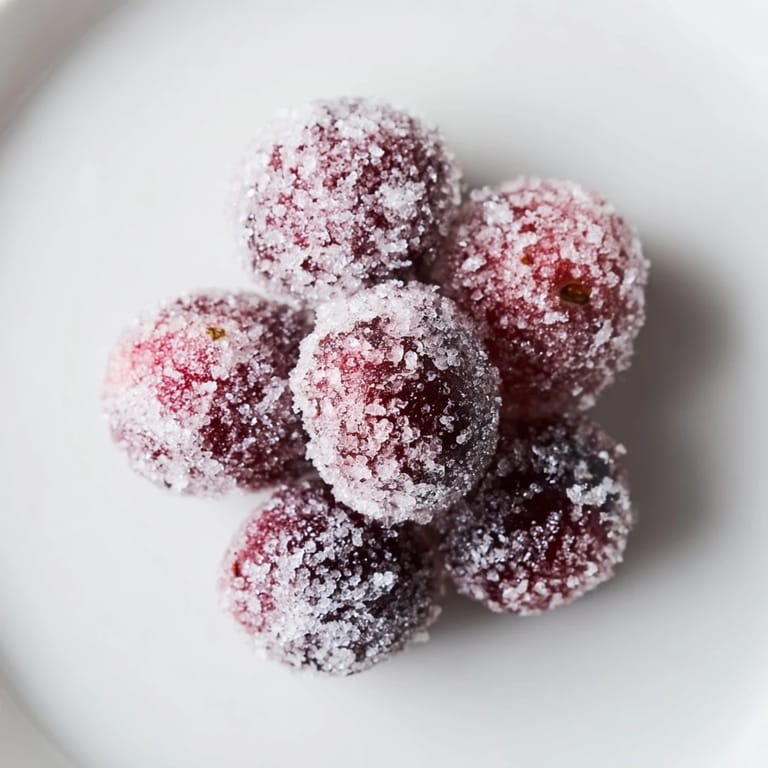 Shiny candied cranberries, coated in sugar, offer a festive sparkle to complete this garnish recipe.