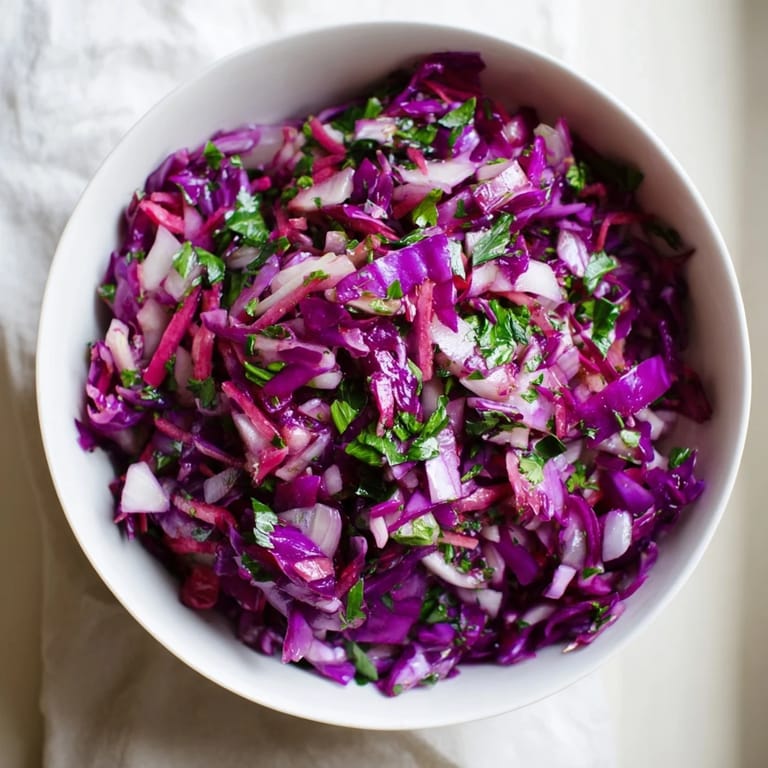 Refreshing, Persian-inspired Shirazi Winter Slaw, a vegan side dish with pomegranate and a bright citrus vinaigrette.