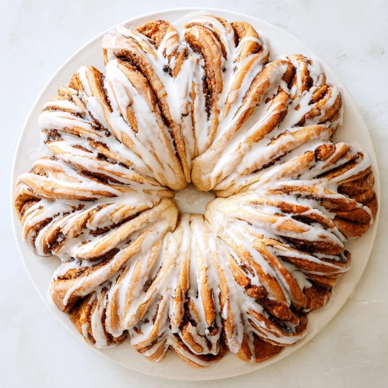 Freshly baked giant snowflake sweet rolls ready to be served, soft pull-apart rolls arranged in a snowflake shape.