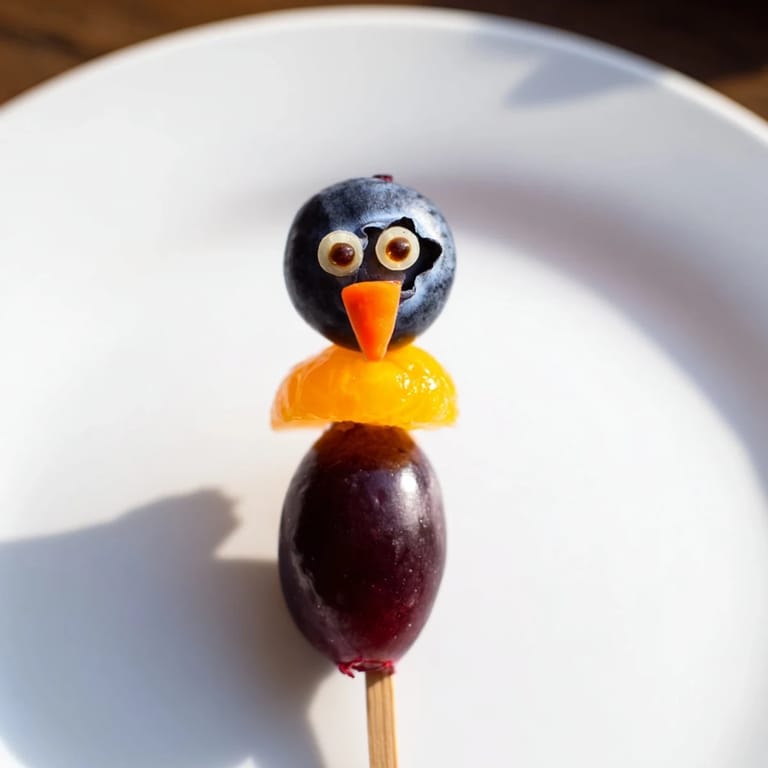 Freshly assembled Penguin Fruit Skewer Army featuring colorful fruit, a playful and delicious kids' party treat.