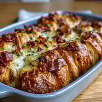 Ham and cheese croissant bake casserole with golden croissants, melty Gruyère, and savory ham baked in a creamy egg custard for a brunch favorite.