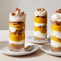 Decadent Thanksgiving dessert shooters layered with creamy pumpkin and spiced cheesecake.  